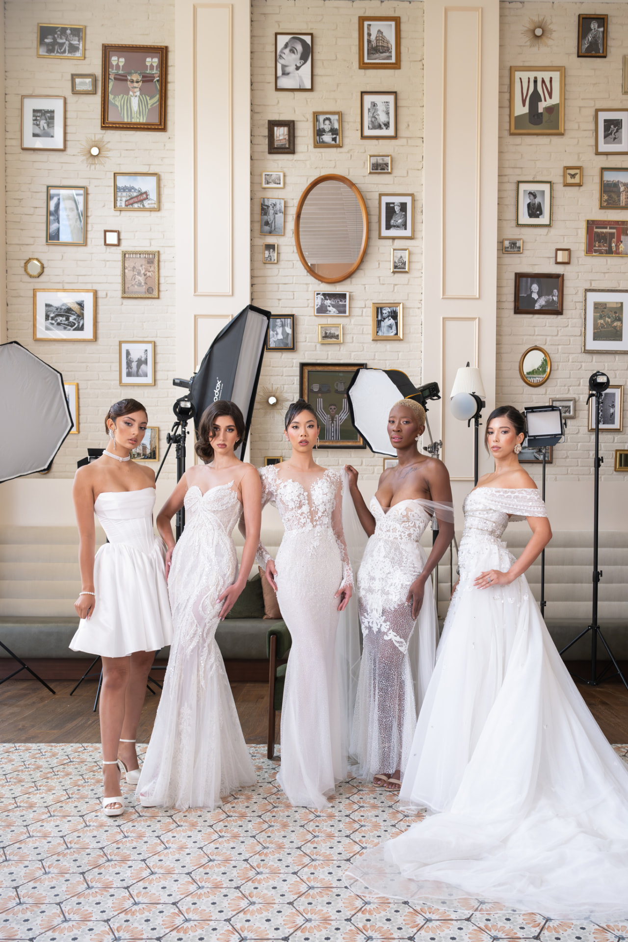 Five models in white couture gowns standing together