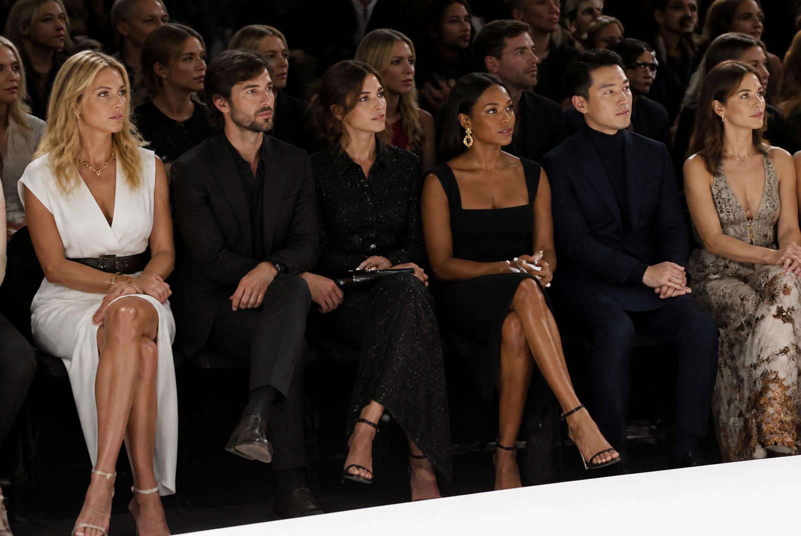 Elegant guests seated front row watching the runway