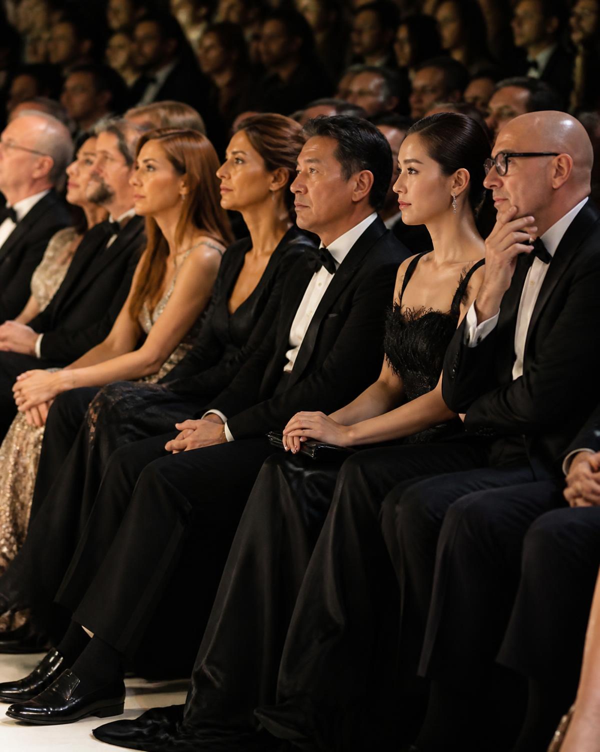 Front row guests in black tie seated at the runway